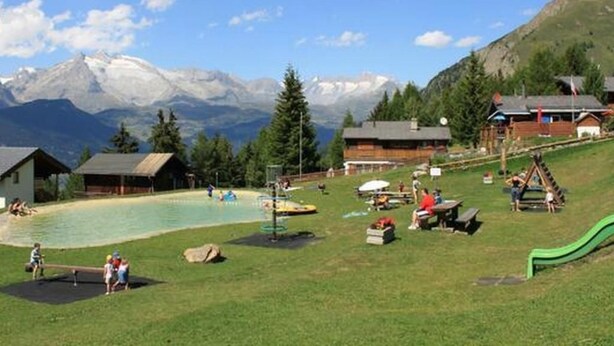 A mountain resort with a swimming pool, outdoor seating, and a playground. - Adlerhorst by Interhome (Rosswald)