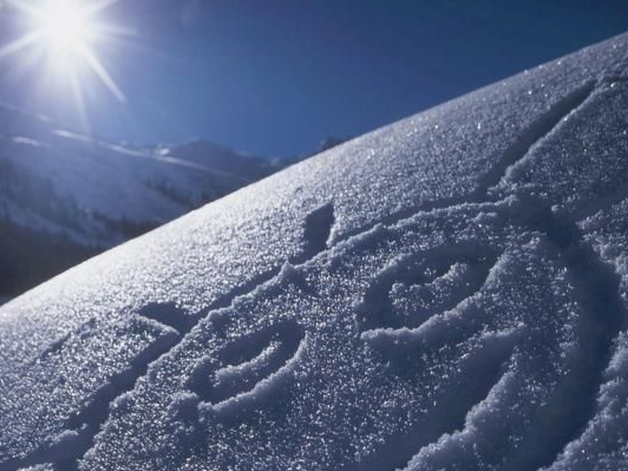 A snow-covered mountain with a ski slope.