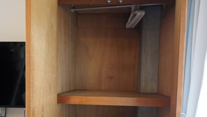A compact room with a wooden wardrobe, a small shelf, and a pull-out shelf. - Tokyo Quiet Residential Studio FMC Asagaya | 3min To Station, Direct Shinjuku (Asagayaminami, Suginami)