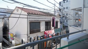 A multi-story building with visible balconies and a metal railing. - Tokyo Quiet Residential Studio FMC Asagaya | 3min To Station, Direct Shinjuku (Asagayaminami, Suginami)