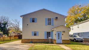A two-story house with a front porch, a garage, and a mailbox. - Explore & Relax! Norfolk Duplex < 1 Mi to Beach (Norfolk)