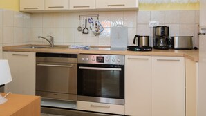 A modern kitchen with stainless steel appliances, including a dishwasher, oven, and coffee maker. - Panoramare by Interhome (Plomin)
