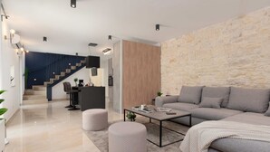 Ein modernes Wohnzimmer mit grauem Sofa, einem Couchtisch und einer Wand mit Steinoptik.