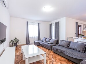 A modern living room with a sofa set, a coffee table, and a TV. - Wohnung "Wohnung Sterna mit Pool" by Interhome (Svetvinčenat)