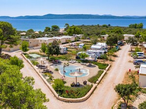 A coastal resort with a swimming pool, RV parking, and beach access.