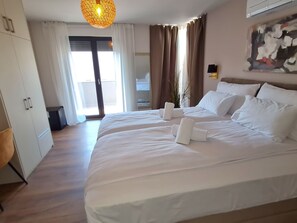 A hotel room with a large bed, a ceiling light, a view of the outdoors, and a painting on the wall. - Villa "Val 22" mit Pool, Fitness und Sauna by Interhome (Poreč/Funtana)