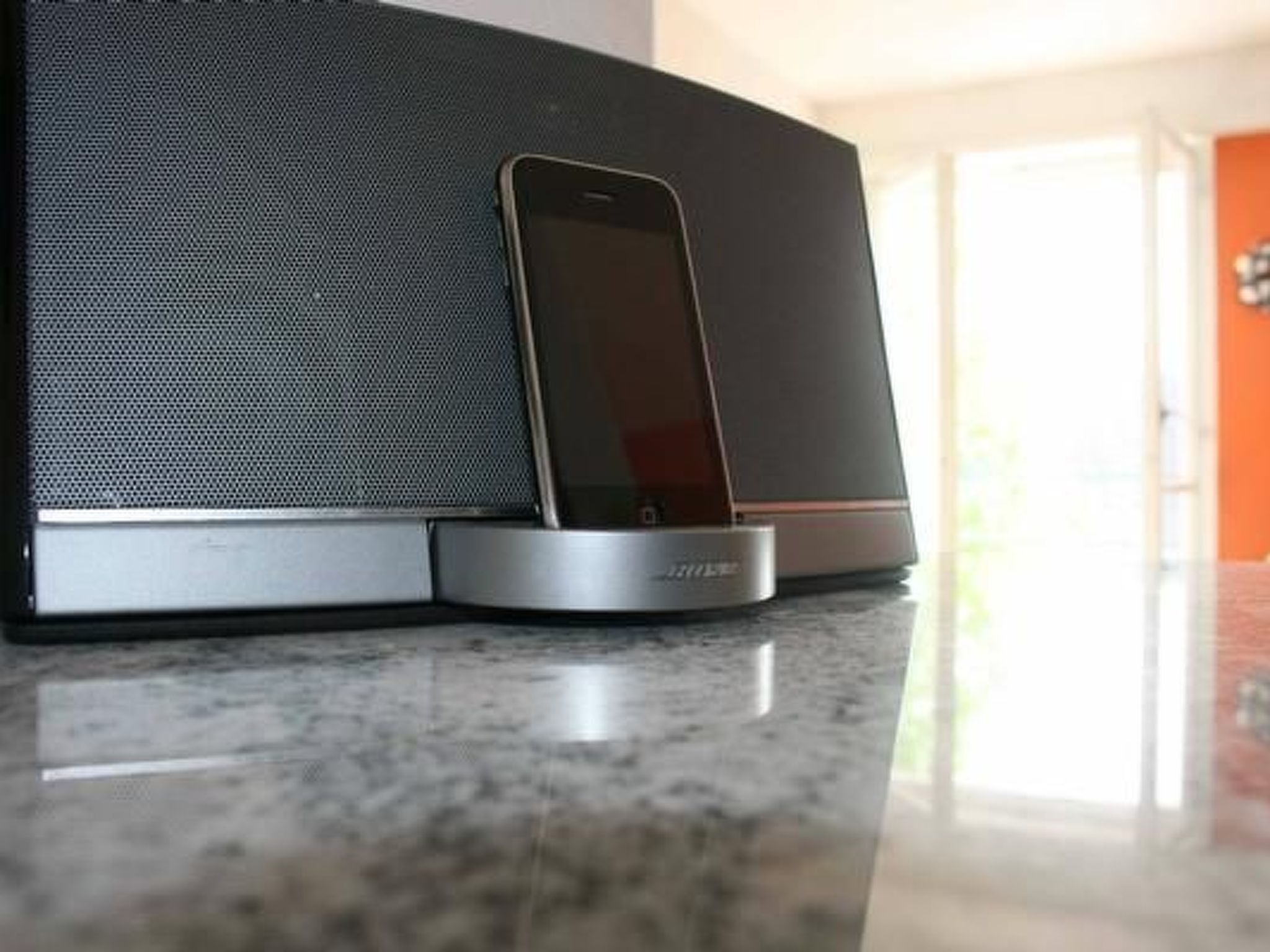 Un teléfono inteligente conectado a una moderna y elegante bocina.