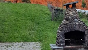 A stone-built outdoor oven in a grassy field with a mountain in the background. - Oberwilen by Interhome (Vitznau)