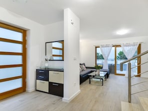 A modern apartment with a living area, a kitchen, and a balcony with a view. - Villa mit Dachterrasse und Pool - Agentur TA Leut by Interhome (Zaton)