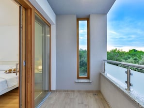 A balcony with a view of greenery, a sliding glass door, and a white sofa. - Villa mit Dachterrasse und Pool - Agentur TA Leut by Interhome (Zaton)