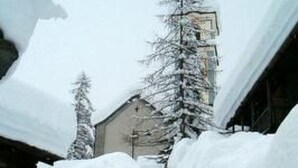 Una escalera cubierta de nieve que lleva a un edificio de estilo arquitectónico tradicional.