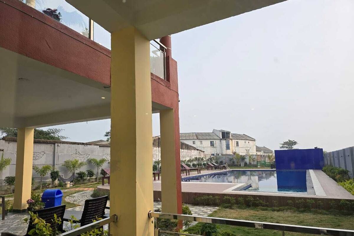 A pool area with a view of a building in the background.