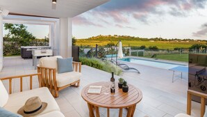 A modern outdoor living area with a pool, seating, and a scenic view of the countryside. - Villa Grofica, beheizter Pool, Taverne, Strandnähe by Interhome (Pula)