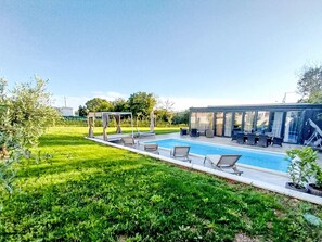 A swimming pool with lounge chairs and a covered seating area. - Hacienda Matea - Oase der Romantik in Strandnähe by Interhome (Pula)