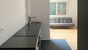A modern kitchen with a black countertop, a built-in oven, and a window above the sink. - "Lake Escape", mit Pool by Interhome (MAROGGIA)