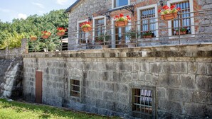 A stone building with multiple windows, some with flower boxes. - Anwesen "Villa Anton" mit eigenem Pool by Interhome (Podgrad)