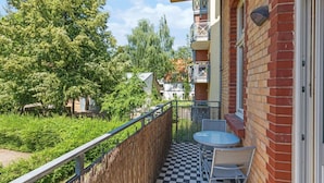 A balcony with a checkered floor, a table, and two chairs. - Gründerzeitvilla by Interhome (Potsdam)