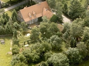 A large house surrounded by dense trees. - in ehemaliger Dorfschule am Dorfrand by Interhome (Bergen)