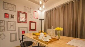 A dining area with a wooden table, chairs, and a tray with breakfast items. - Say Volga (Guwahati)
