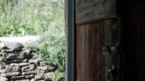 A rustic wooden door with a metal latch and a metal ring handle. - La Stalla by Interhome (Faido)