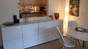 A modern kitchen with an archway leading to a dining area. - Residenza al Mulin by Interhome (Ascona)