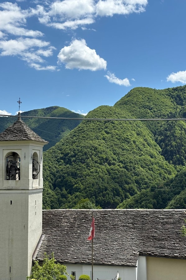 A building with a stone bell tower and a flag.