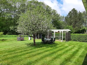 A well-maintained garden with a gazebo, a picnic table, and neatly trimmed grass. - Fewo Stricker 32 by Interhome (Walkenried)