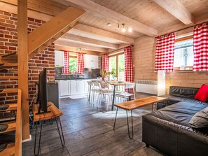 A modern interior with a dining area, kitchen, and seating space. - Landhaus mit gemeinschaftlichem Pool by Interhome (Szklarska Poreba)