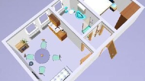 Ein 3D-Modell eines Hotelzimmers mit Bett, Schreibtisch, Stuhl und einer kleinen Sitzecke mit Tisch und Stühlen.
