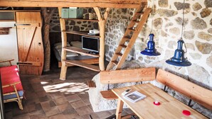 A rustic room with a loft bed, wooden shelves, a desk, and stone walls. - in idyllischer Lage im Süden Korsikas * by Interhome (Serra-di-Ferro)