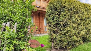 A wooden cabin with a balcony, surrounded by lush greenery and a small garden. - Chalet  " Jagdhaus" by Interhome (Philippsreut)