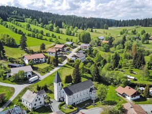 A village with a church, residential buildings, and green fields. - Chalet  " Jagdhaus" by Interhome (Philippsreut)