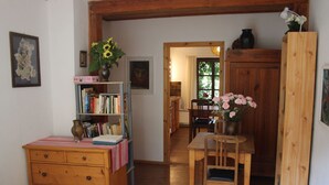 A cozy room with a bed, a wooden desk, a bookshelf, and a dining area. - Daddeldu by Interhome (Börgerende)