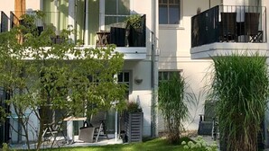A modern two-story building with balconies, large windows, and outdoor seating areas. - in Strandnähe by Interhome (Bad Doberan)