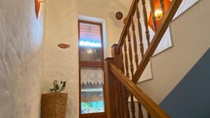 A staircase with wooden railings and a textured wall. - Appartement Wimmer by Interhome (Bad Füssing)