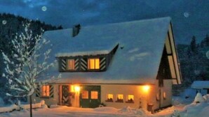 A snow-covered house with a sloped roof and a chimney, surrounded by snow. - Tauchert by Interhome (Baiersbronn)