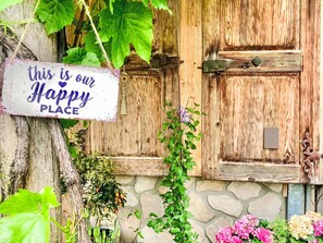 A rustic wooden door with a sign that reads 'this is our Happy PLACE.' - Scheftenau by Interhome (Wattwil)