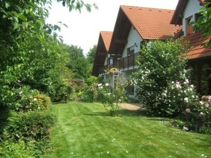 A residential building with a well-maintained garden, a visible balcony, and a red-tiled roof. - am Wiesengrund in Venningen by Interhome (Venningen)