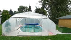 A covered swimming pool with a diving board and a small deck area. - für 16 Personen mit Terrasse by Interhome (Sudwalde)