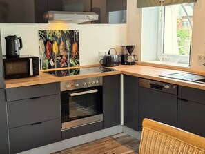 A modern kitchen with a built-in oven, a microwave, a coffee maker, and a toaster. - Alles im grünen Bereich by Interhome (Bohmstedt)