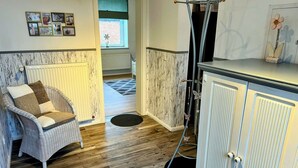 A cozy room with a wicker chair, a cabinet, and a radiator. - Alles im grünen Bereich by Interhome (Bohmstedt)
