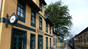 A historic building with a clock, green doors, and a sign reading "Göhren". - Villa Granitz by Interhome (Baabe)