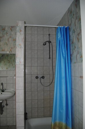 A bathroom with a shower, a sink, and a toilet. - Schule 6 by Interhome (Eckernförde)