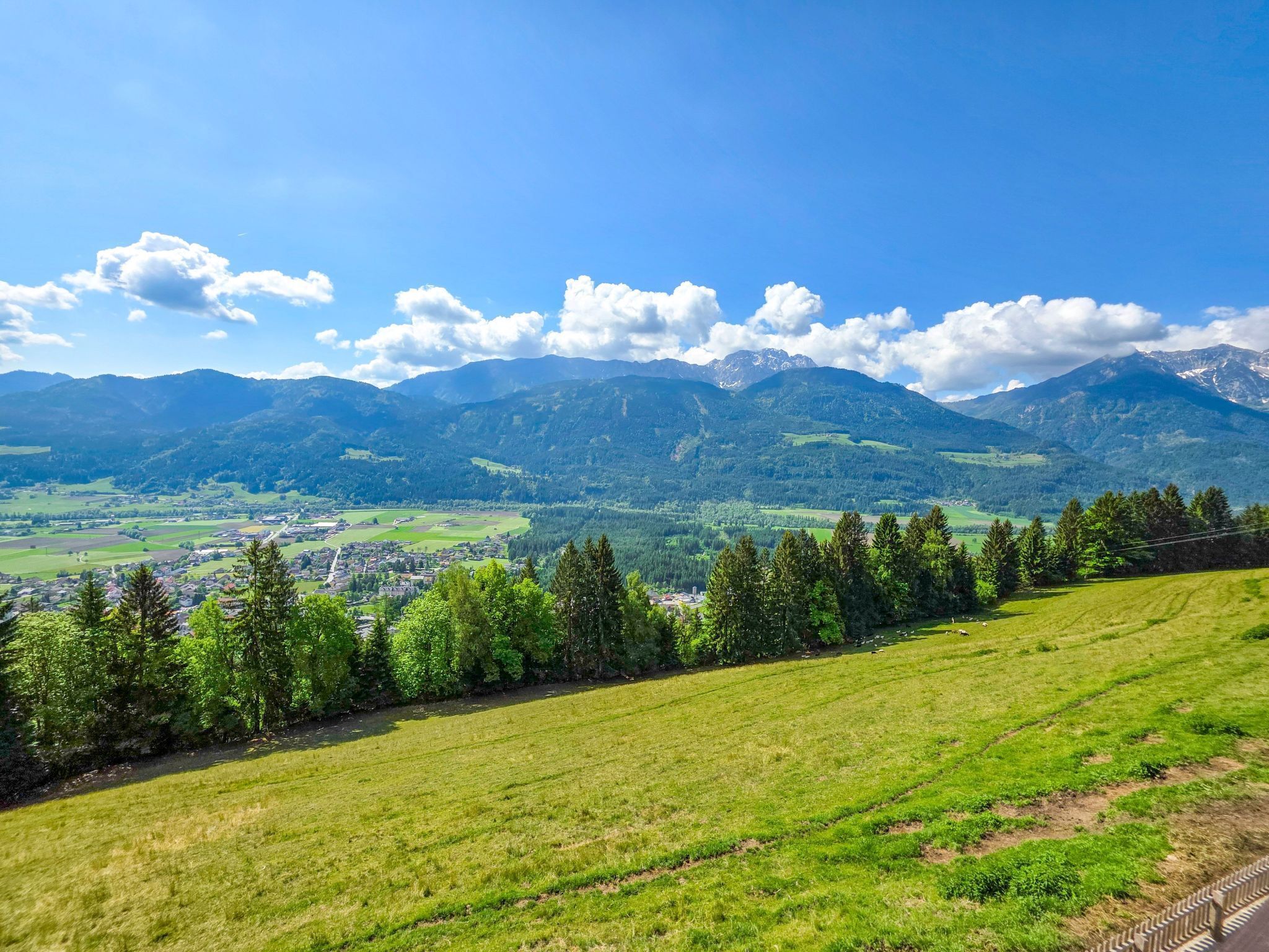A panoramic view of a mountainous landscape with a town nestled in the valley.