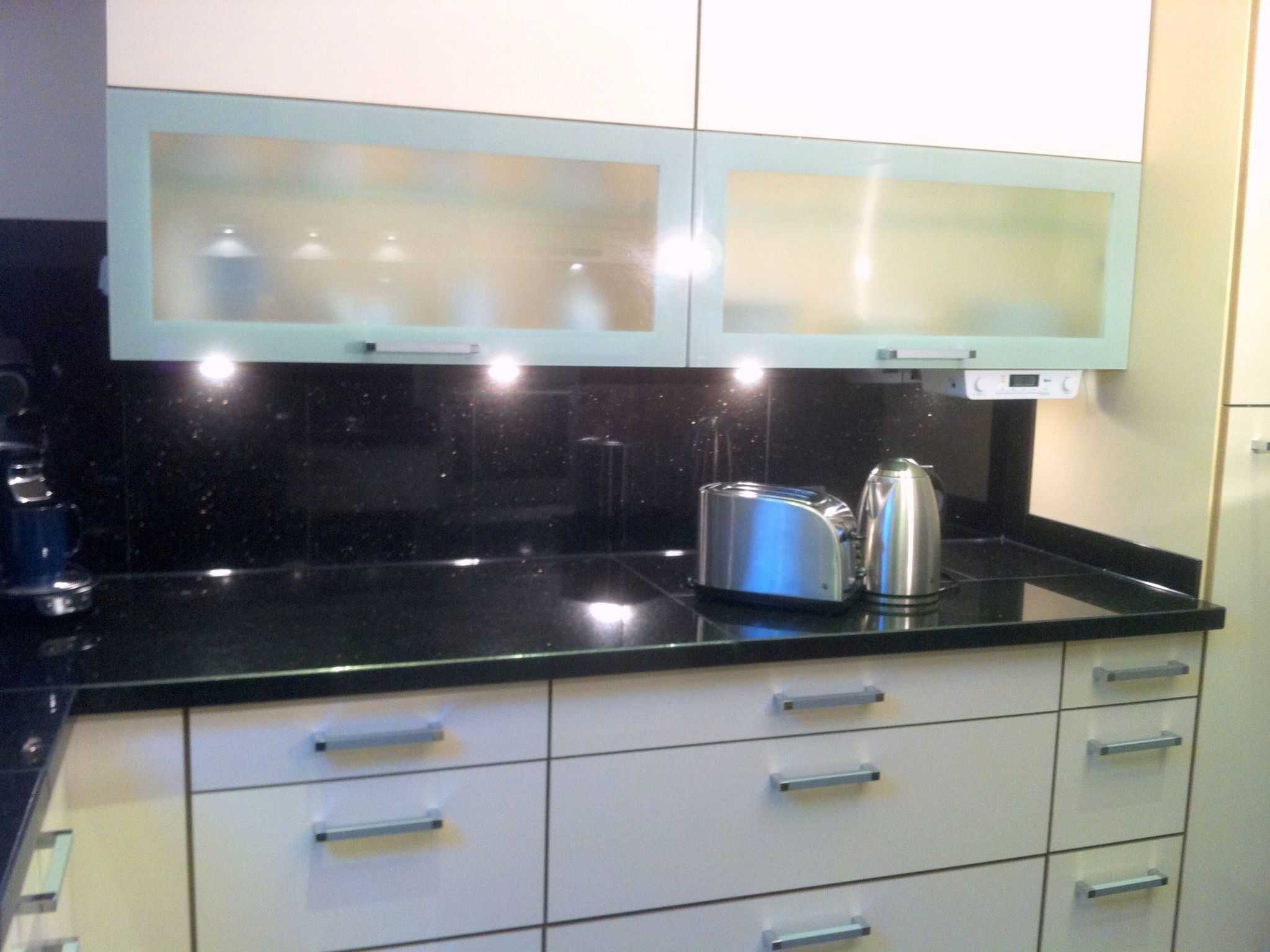 Een koelkast, een oven, kookgerei, borden en bestek