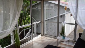 A balcony with a view of greenery and a white fence. - Typisch schwedisches Ferienhaus mit Garten by Interhome (Vena)
