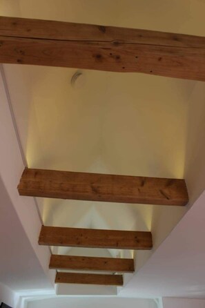 A staircase with wooden beams and a light fixture. - AAR NORDSEE APPARTEM by Interhome (Dangast)