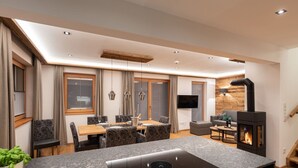 Eine moderne Küche mit Einbauherd, ein Essbereich mit Tisch und Stühlen sowie eine Wohnbereich mit Sofa und Kamin.
