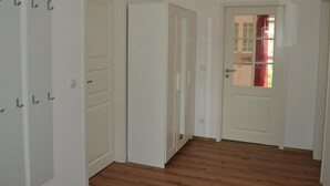 A hallway with white doors and a wooden floor. - Appartement mit WLAN by Interhome (Hoppegarten)