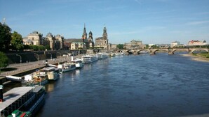 A river with boats, a bridge, and historic buildings. - Ferienwohznung Huhle by Interhome (Rabenau)